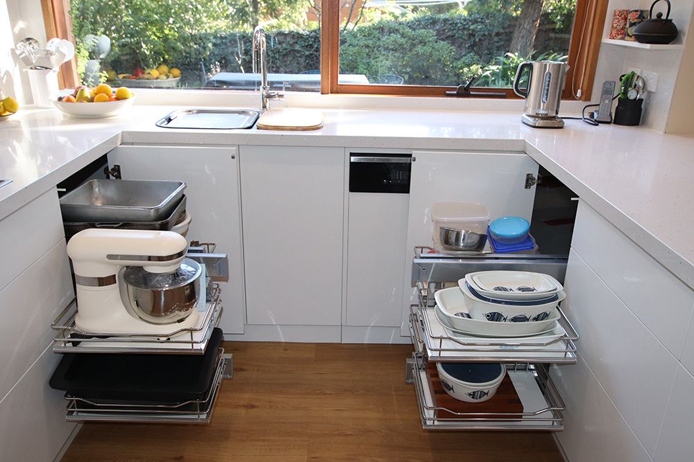 Kitchen pantry corner with pull out wire storage baskets